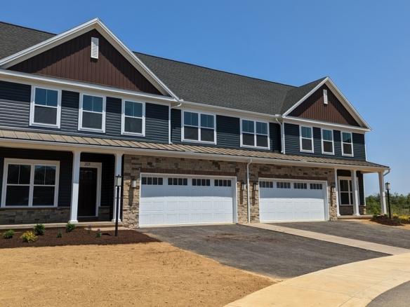 a row of houses with a two-car garage on each side
