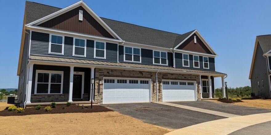 a row of houses with a two-car garage on each side