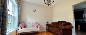 a living room filled with furniture and a chandelier