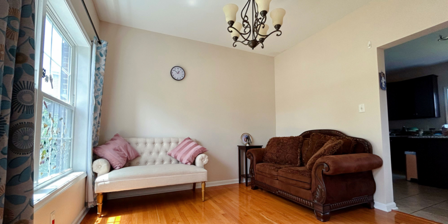 a living room filled with furniture and a chandelier