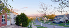 a street with houses and mountains in the distance