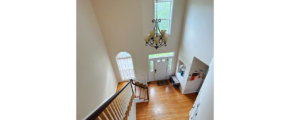 an overhead view of the entry and stairs with wood floors