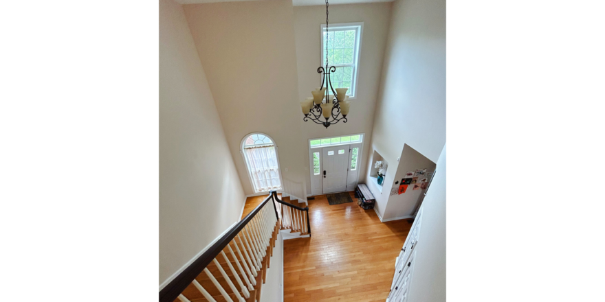 an overhead view of the entry and stairs with wood floors