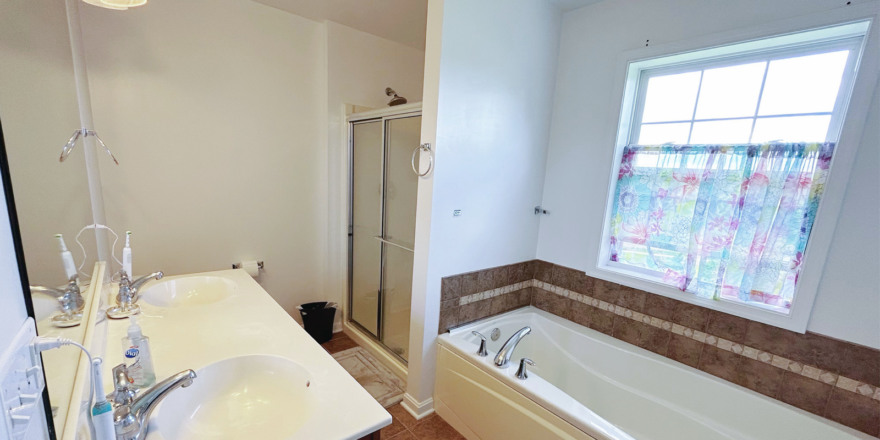 a bathroom with a sink, tub and shower