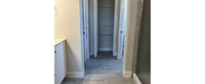 bathroom with vanity on left and shower on right and a view of closet directly ahead