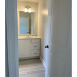 a bathroom with a sink and mirror in it