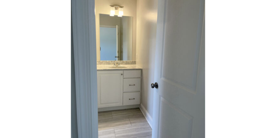 a bathroom with a sink and mirror in it