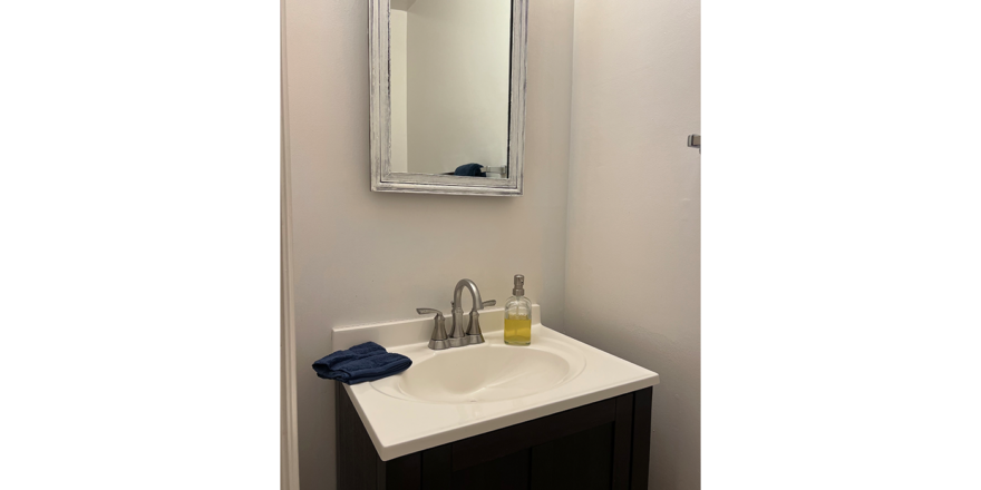 a bathroom sink with a mirror above it