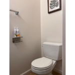 a white toilet sitting in a bathroom