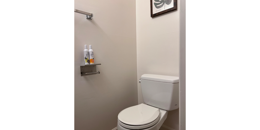 a white toilet sitting in a bathroom