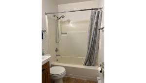 a white bath tub sitting next to a toilet