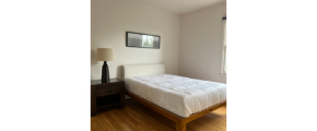 a bed sitting in a bedroom on top of a hard wood floor