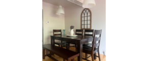 a dining room table with chairs and a bench