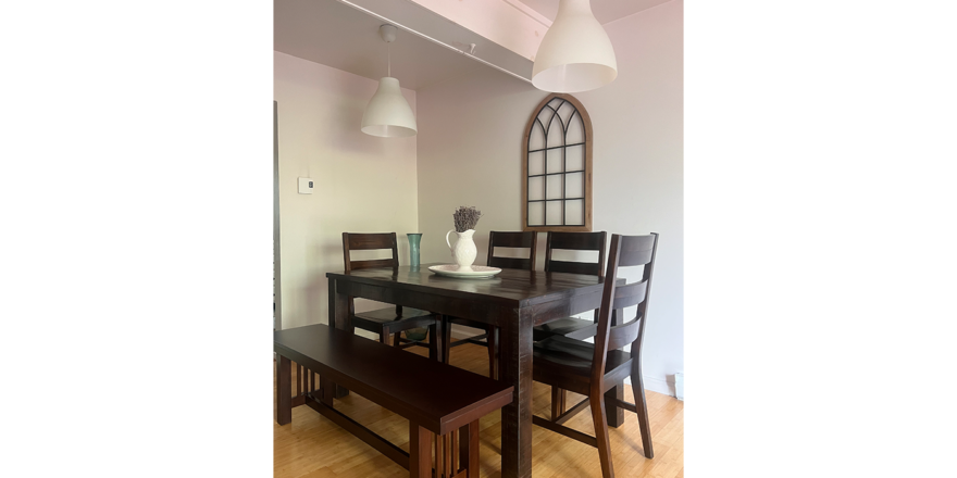 a dining room table with chairs and a bench