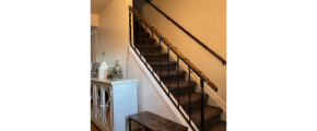 a stair case next to a white wooden cabinet