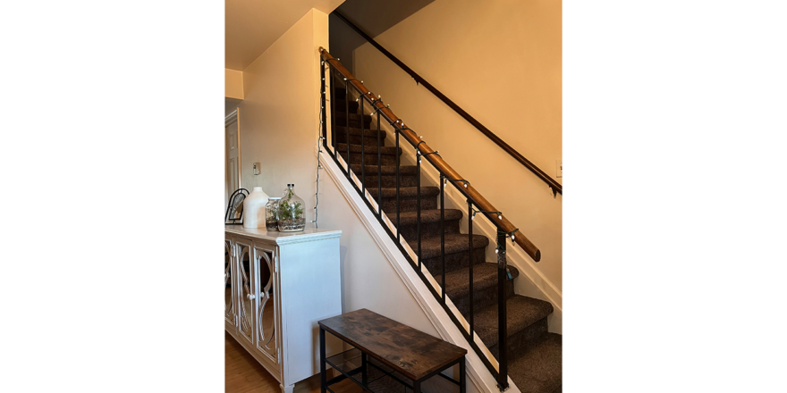 a stair case next to a white wooden cabinet