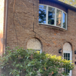 a brick house with a window and door