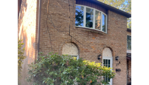 a brick house with a window and door
