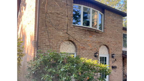 a brick house with a window and door