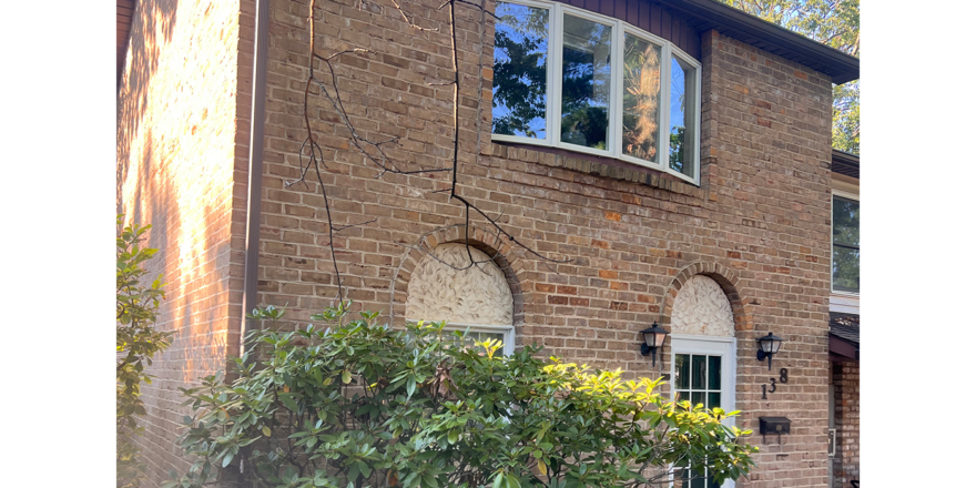 a brick house with a window and door