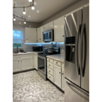 a kitchen with stainless steel appliances and white cabinets