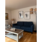 a living room with a blue couch and a coffee table