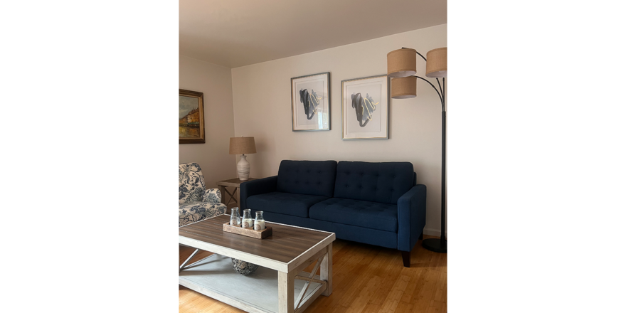 a living room with a blue couch and a coffee table