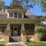 a brick house with a large front porch