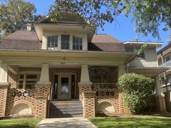 a brick house with a large front porch