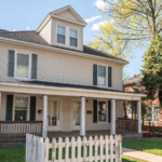 a house with a white picket fence in front of it