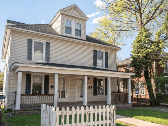 a house with a white picket fence in front of it