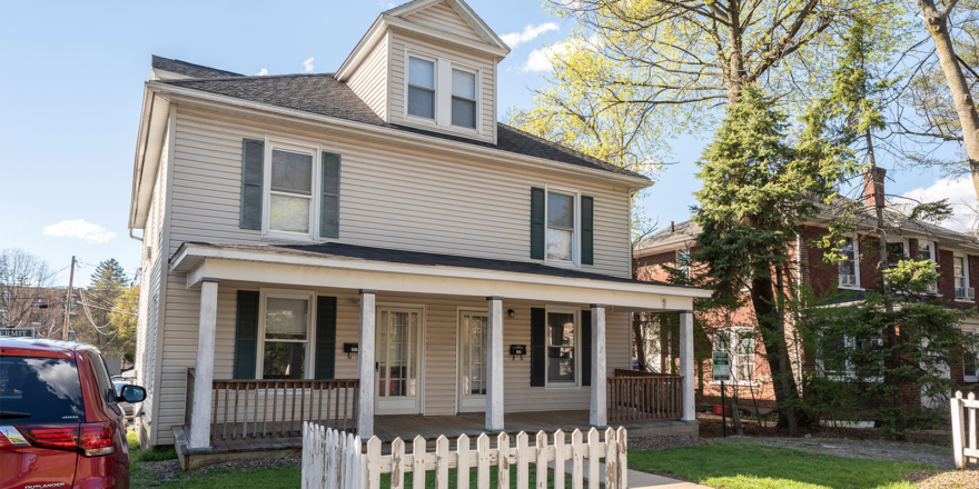 a house with a white picket fence in front of it