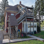 a red house with a balcony and stairs