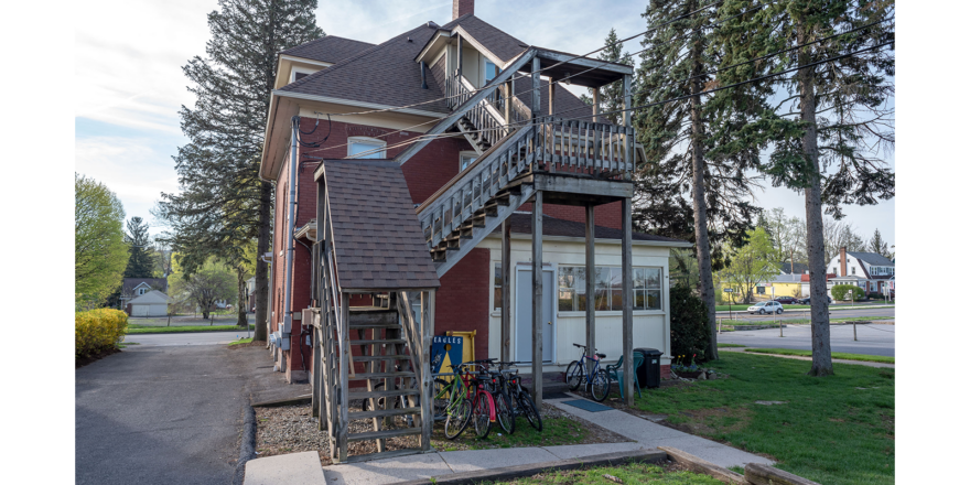 a red house with a balcony and stairs