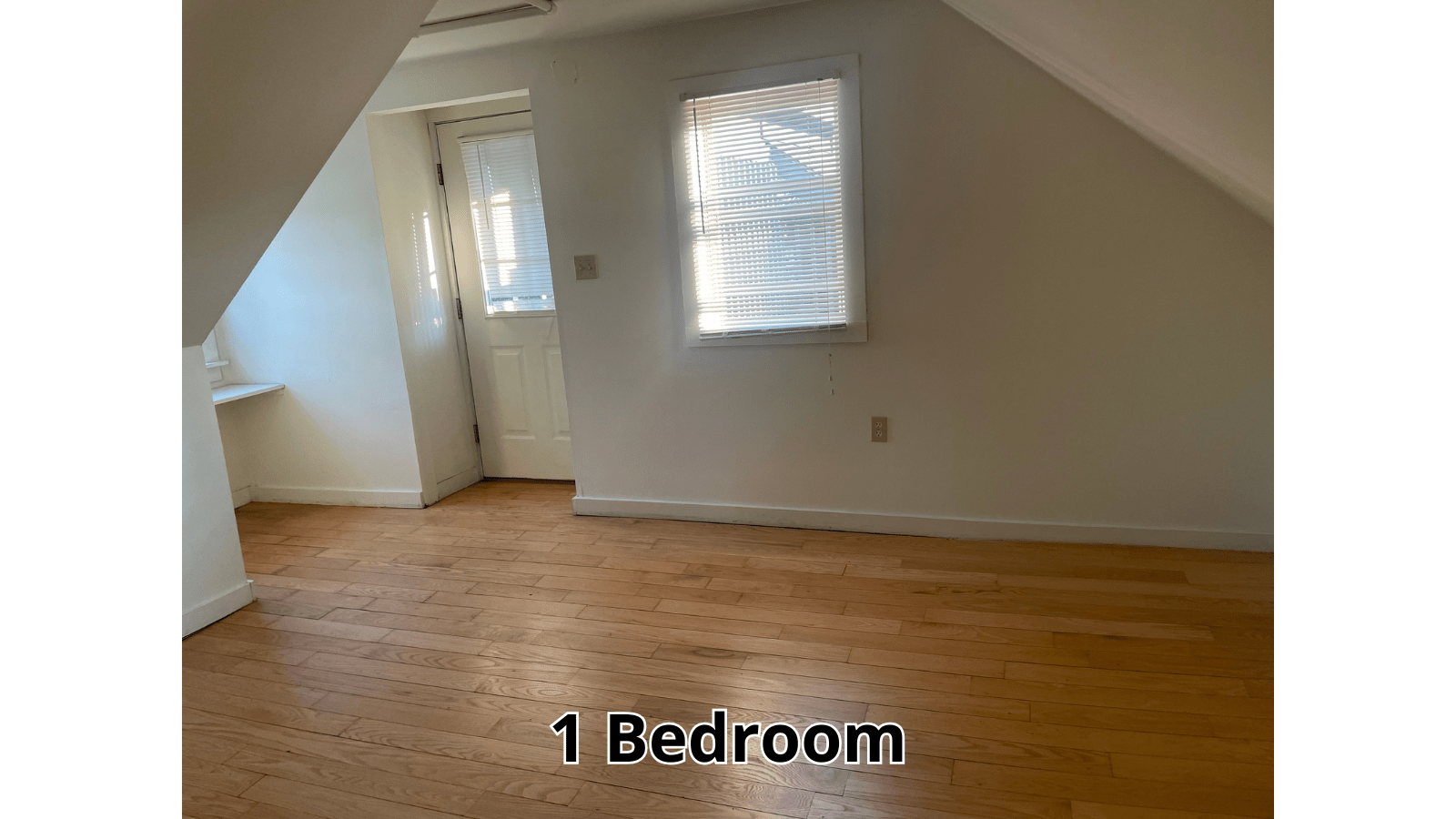 Attic bedroom with hardwood floor