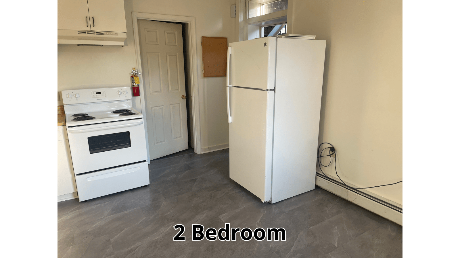 Kitchen with white stove and refrigerator