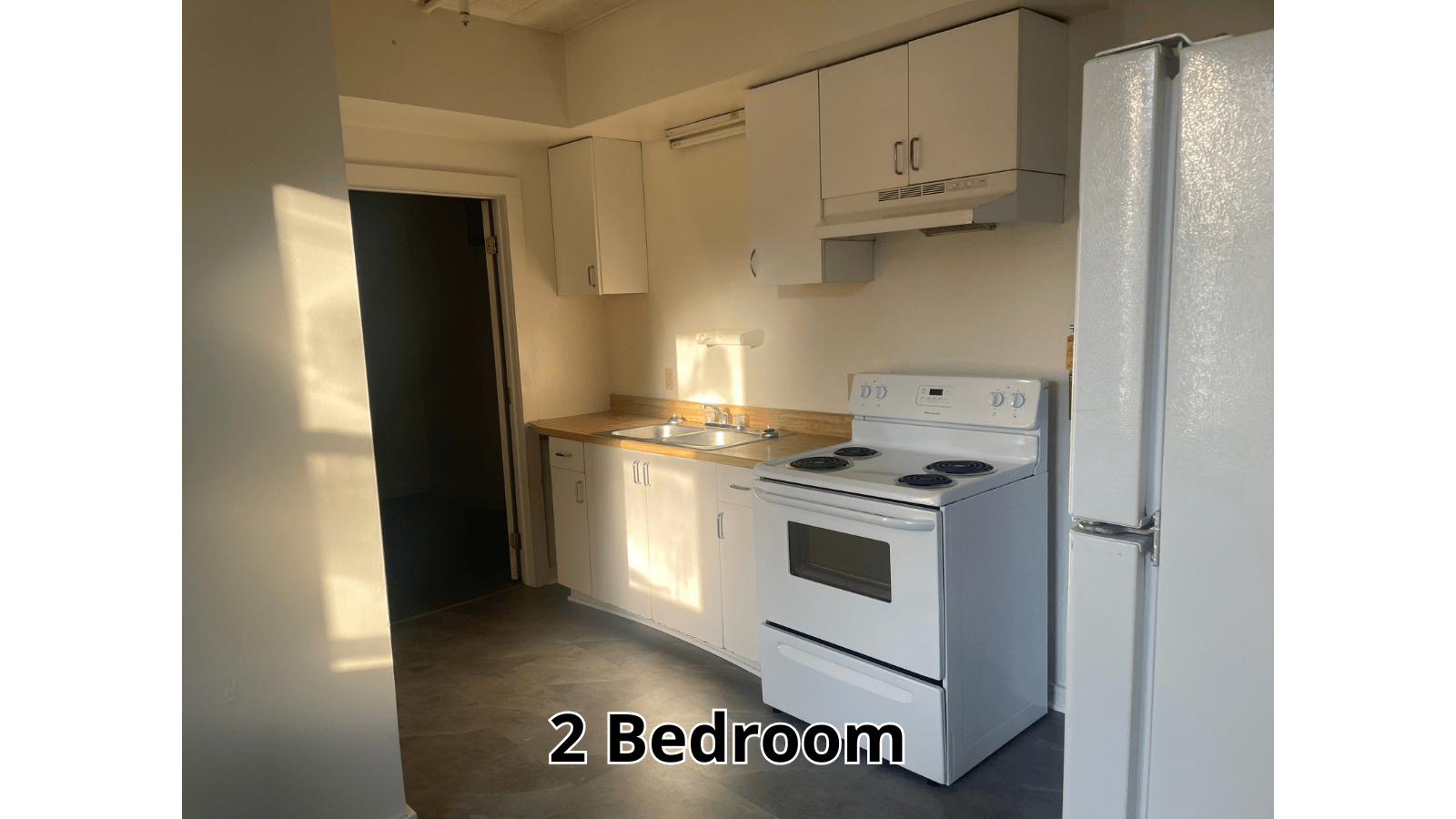 White kitchen with stove and refrigerator
