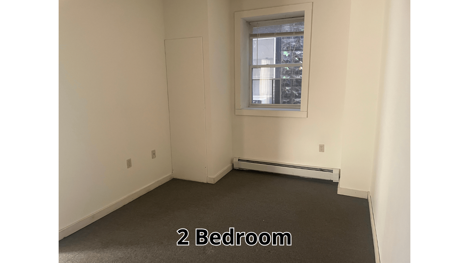 Empty bedroom with window and radiator