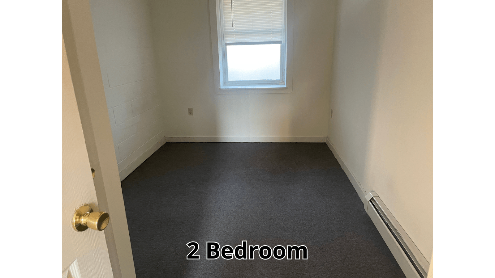 Empty bedroom with dark carpet