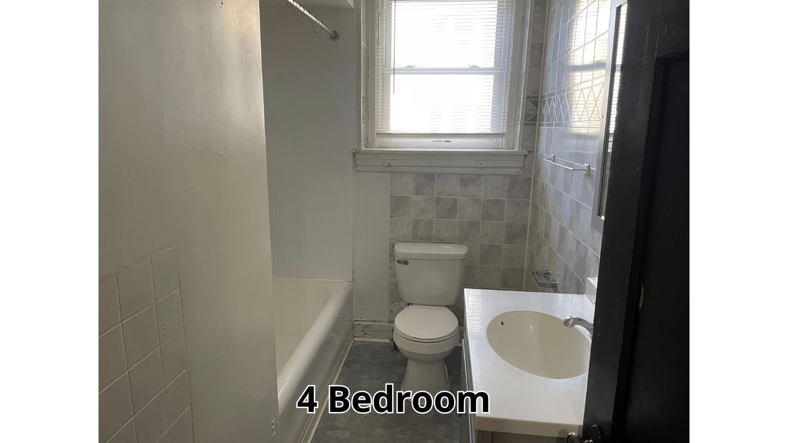 Bathroom with tub, toilet, and sink
