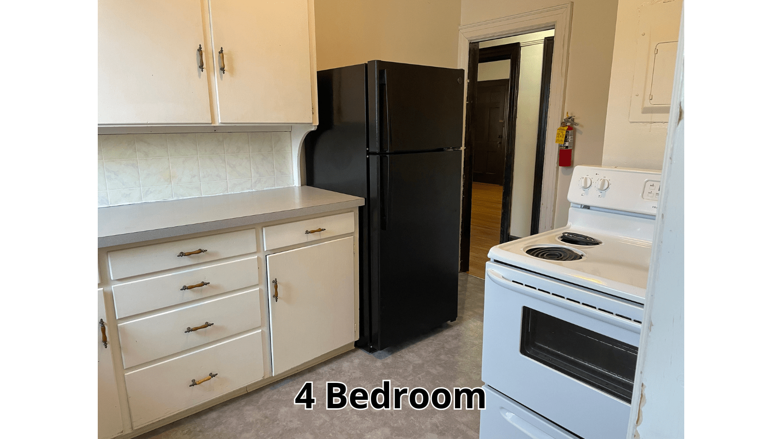 Kitchen with stove, refrigerator, and cabinets