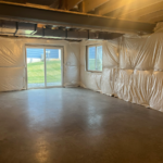 an empty room with some white plastic covering the walls