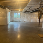 an empty room with white tarps covering the walls