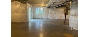 an empty room with white tarps covering the walls
