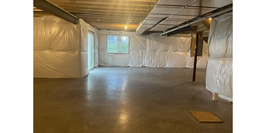 an empty room with white tarps covering the walls
