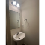 a bathroom with a sink and mirror in it