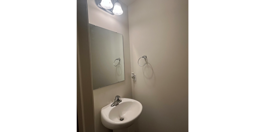 a bathroom with a sink and mirror in it