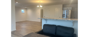 an empty living room and kitchen in a new home