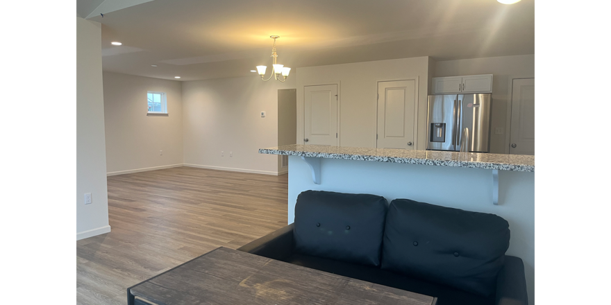 an empty living room and kitchen in a new home