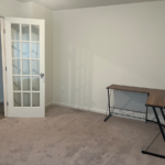 an empty room with a table and a door